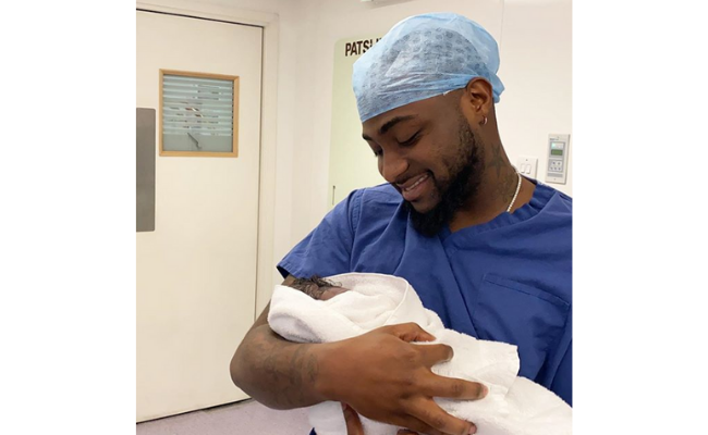 Davido carrying his newborn son, David Jr