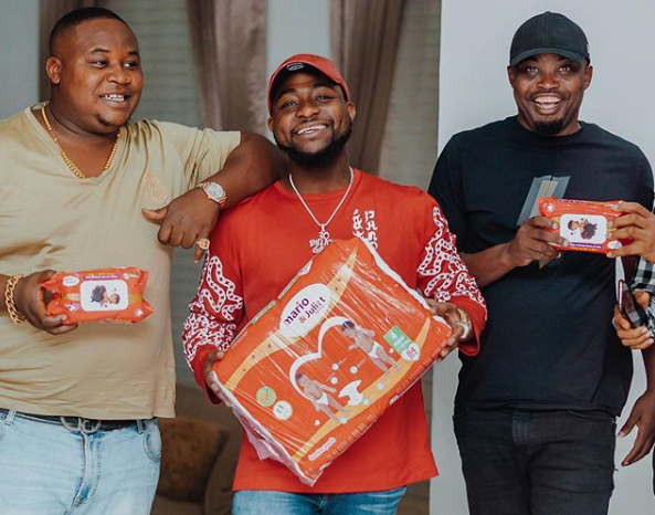 Davido with a pack of mario and Juliet diapers