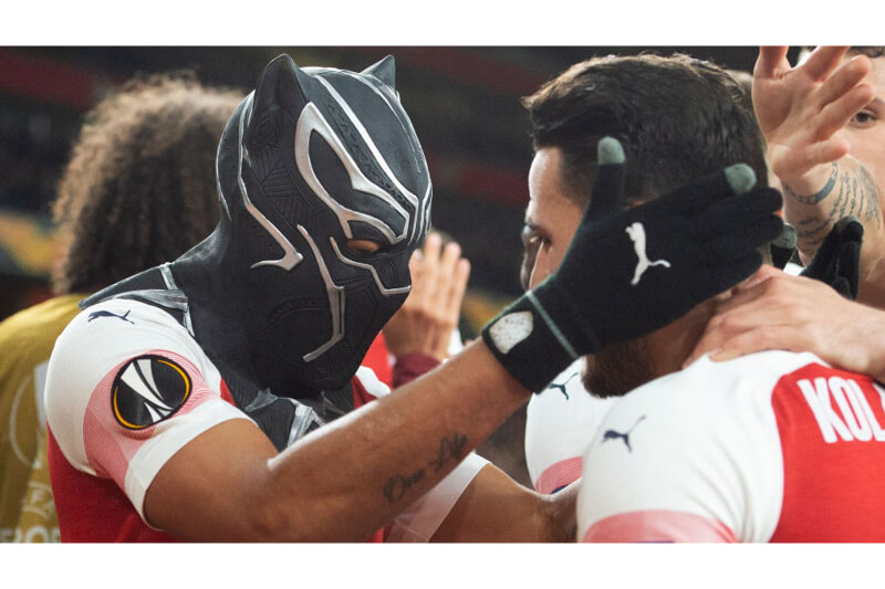Aubameyang pulling a Black Panther mask for celebration