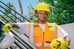 Woman Engineer Holding Hardhats