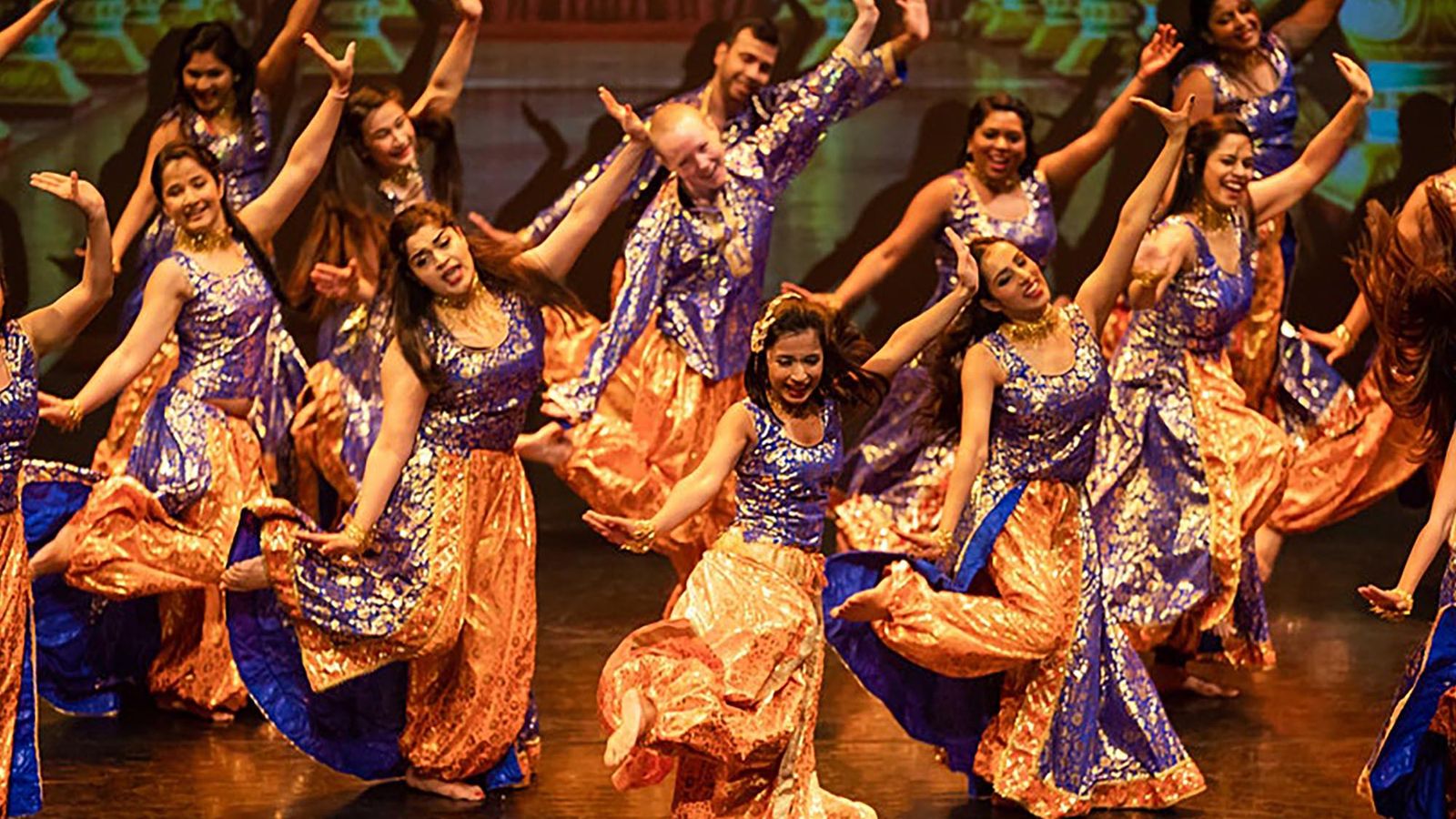 Vibrant Bollywood dance performance with colorful costumes on stage