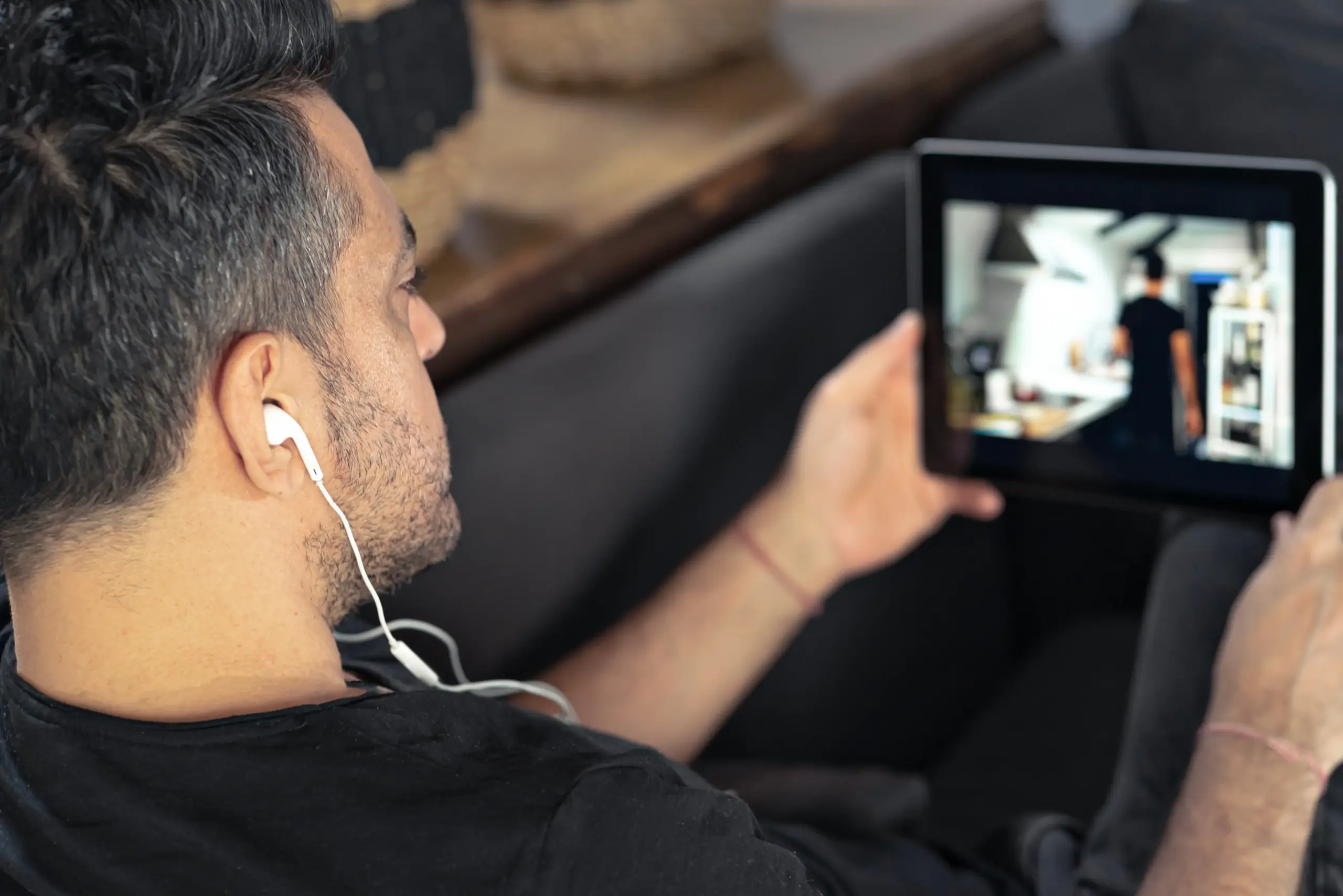 Flat lay of cord cutting essentials including antenna, streaming stick, and smartphone with sports app