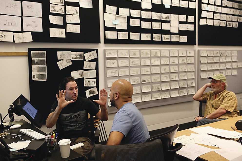 Animation studio review room with team watching storyboard panels on a large screen