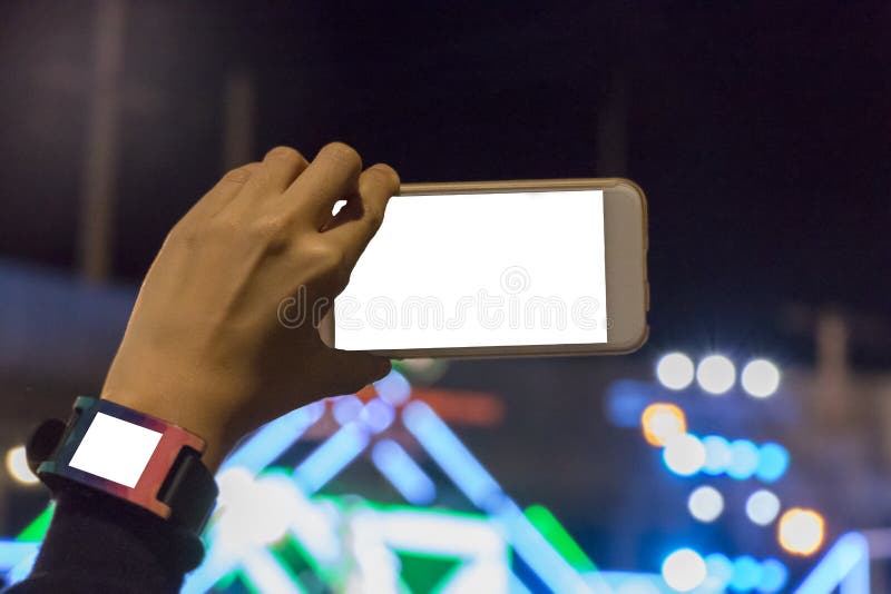 Hand holding a smartphone showing streaming statistics in front of a recording studio backdrop
