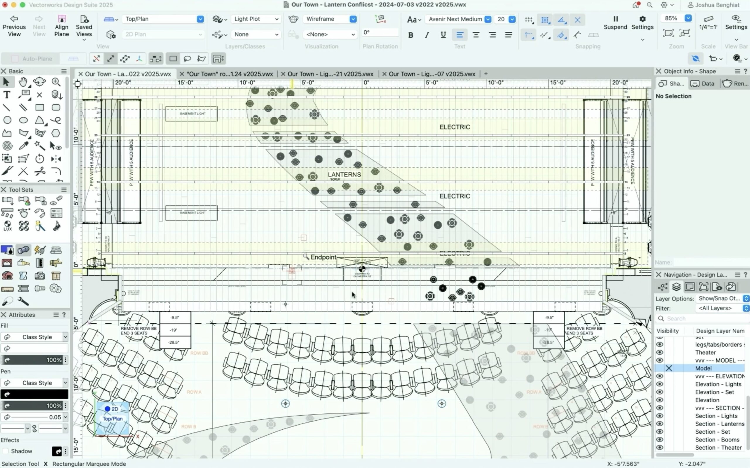 Lighting design plotting session with light plot drawings, Vectorworks software, and gel swatch books