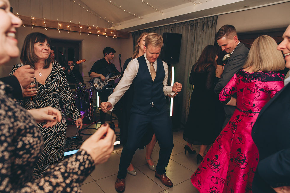 Intimate three-piece wedding band performing at a smaller indoor reception