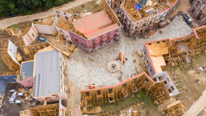 Aerial view of a massive blockbuster film set with elaborate period architecture and hundreds of crew