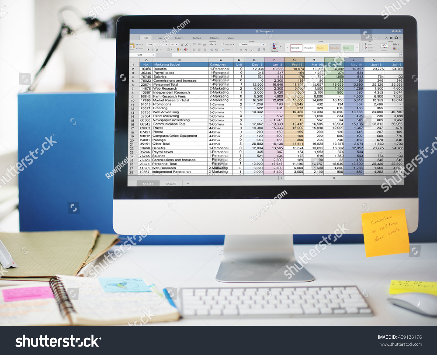 Film budget spreadsheet on laptop screen with calculator and financial documents on a desk