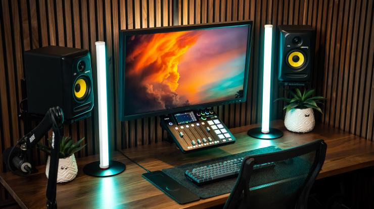 Mid-range YouTube creator desk setup with camera, microphone, key light, and editing software