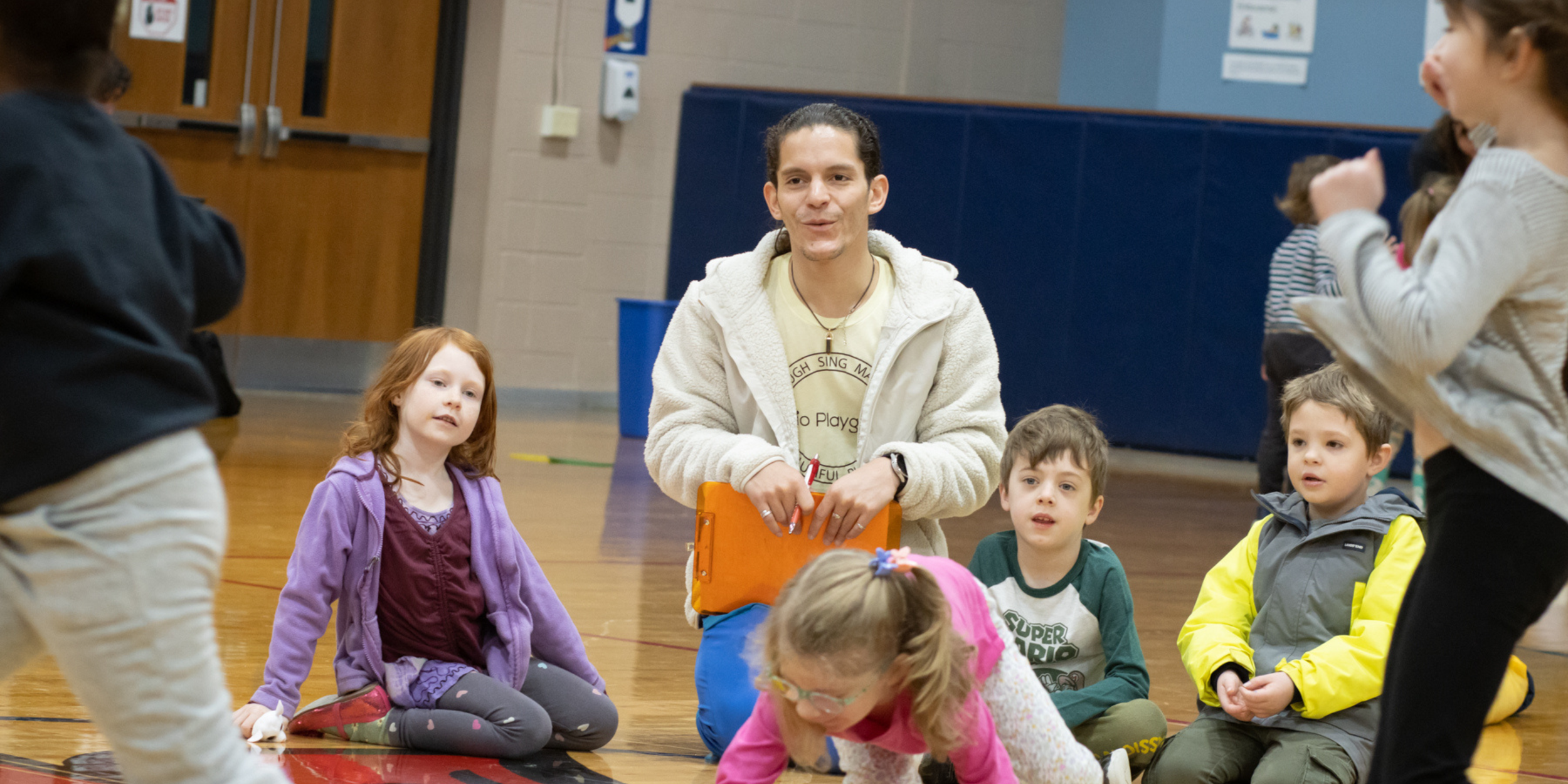 Children participating in an acting class with a friendly coach in a bright studio