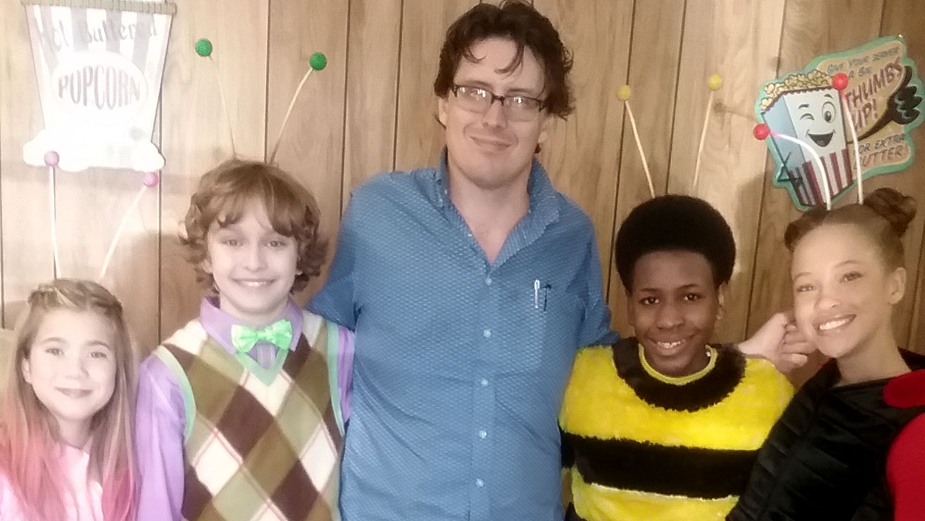 Child actor studying with a studio teacher on a film set