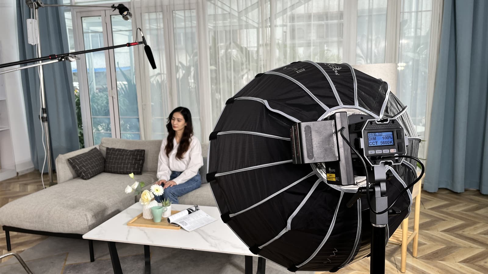Content creator filming a YouTube video with professional camera and ring light setup