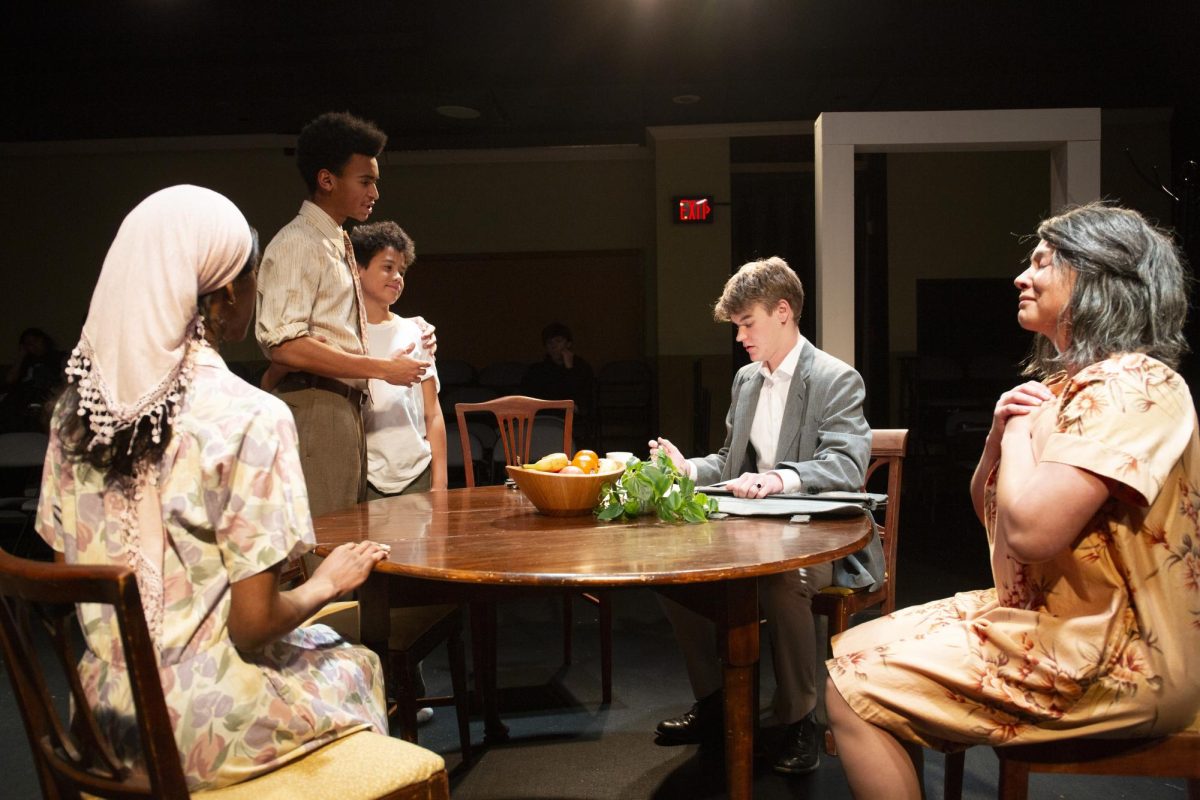 Diverse group of acting students in a black box theater with two performers doing a scene while classmates watch