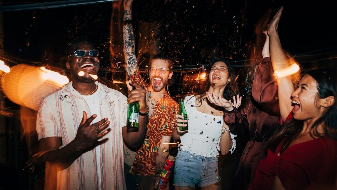 Group of independent filmmakers celebrating together on set after wrapping a scene