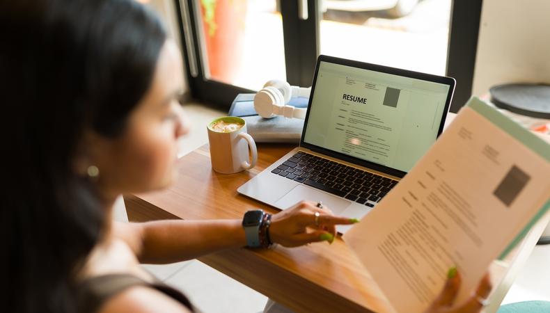 Aspiring actor working on their acting resume at a home desk