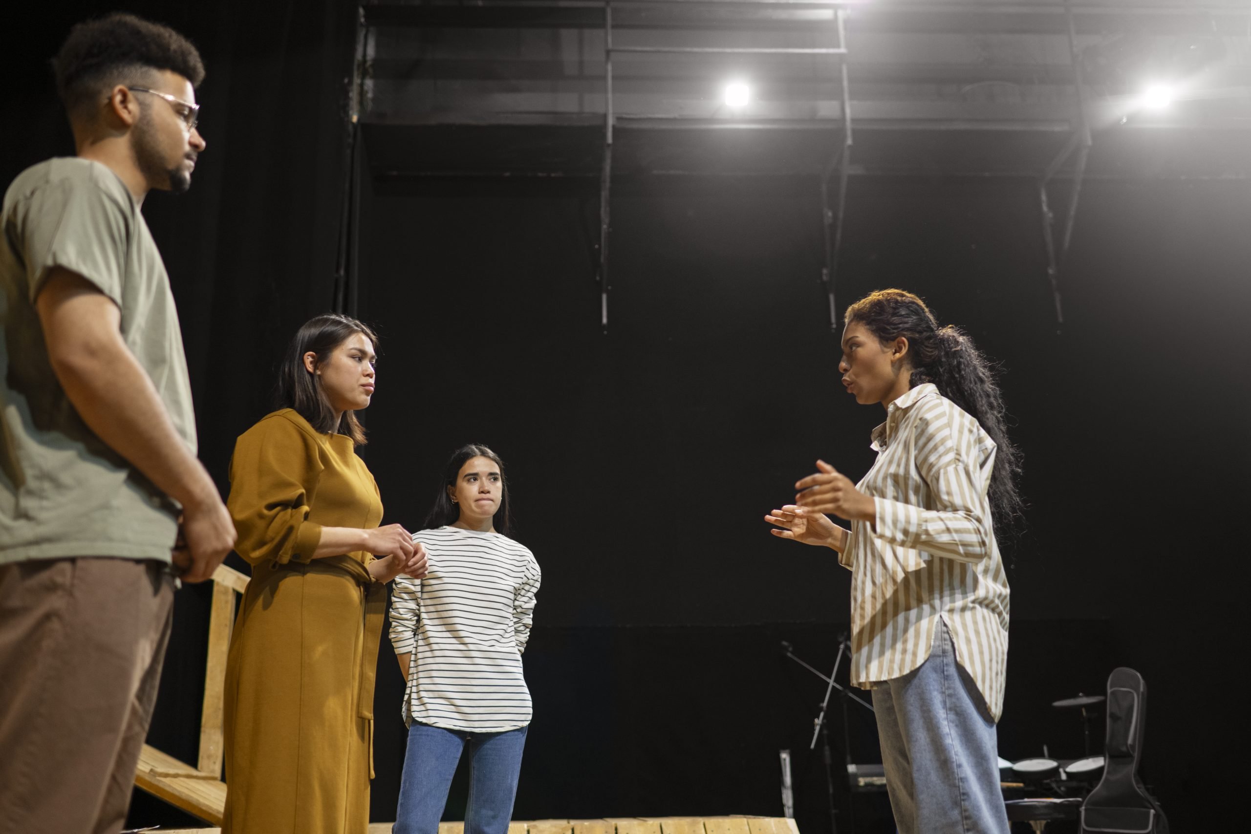 Acting class with students doing improv exercises in a rehearsal studio
